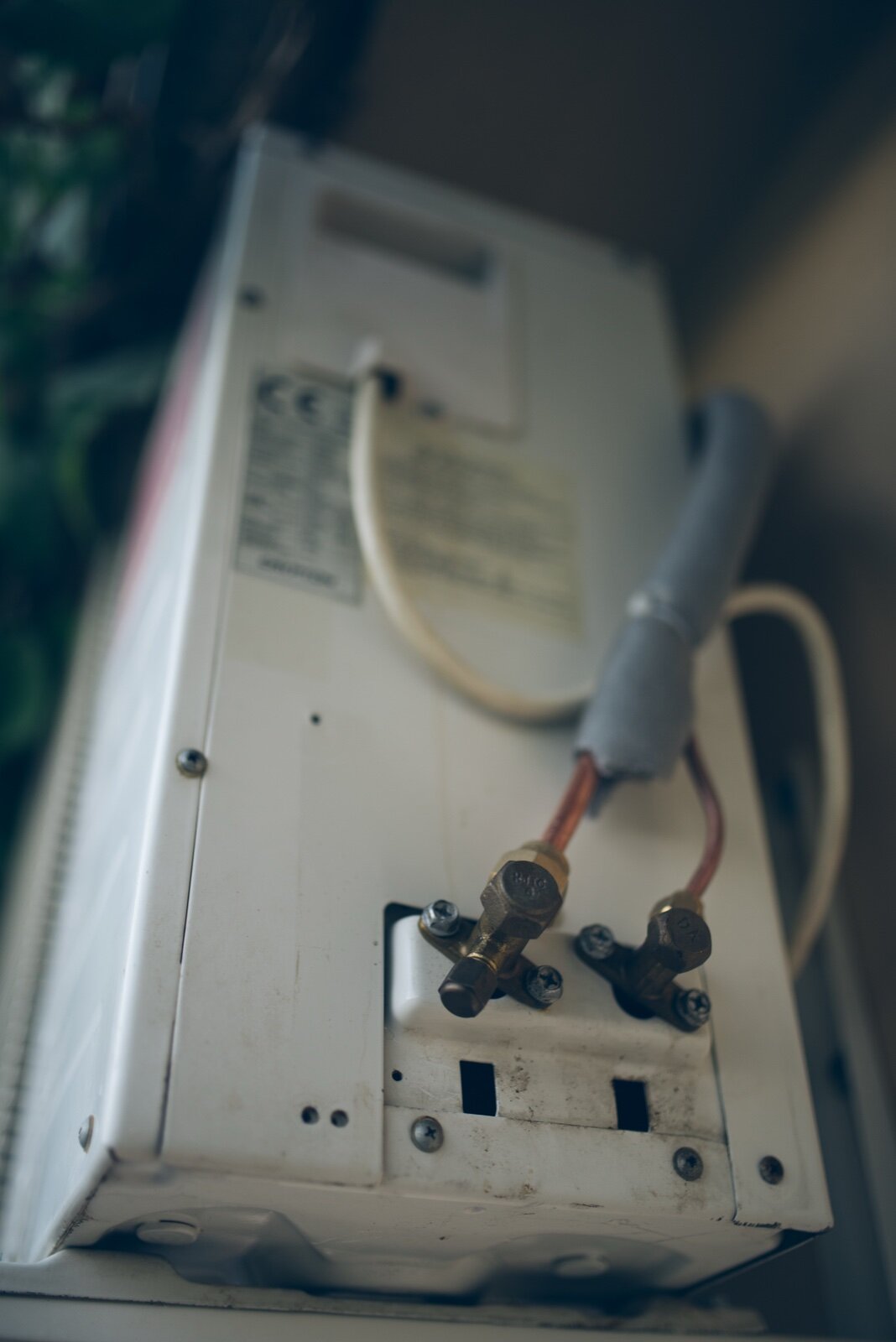 Copper refrigerant pipework and service valves on a split air conditioning unit
