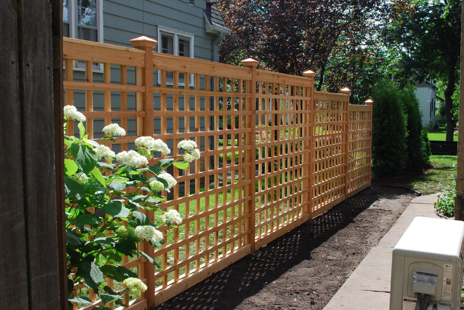 Timber lattice screen panels used for privacy along a side boundary