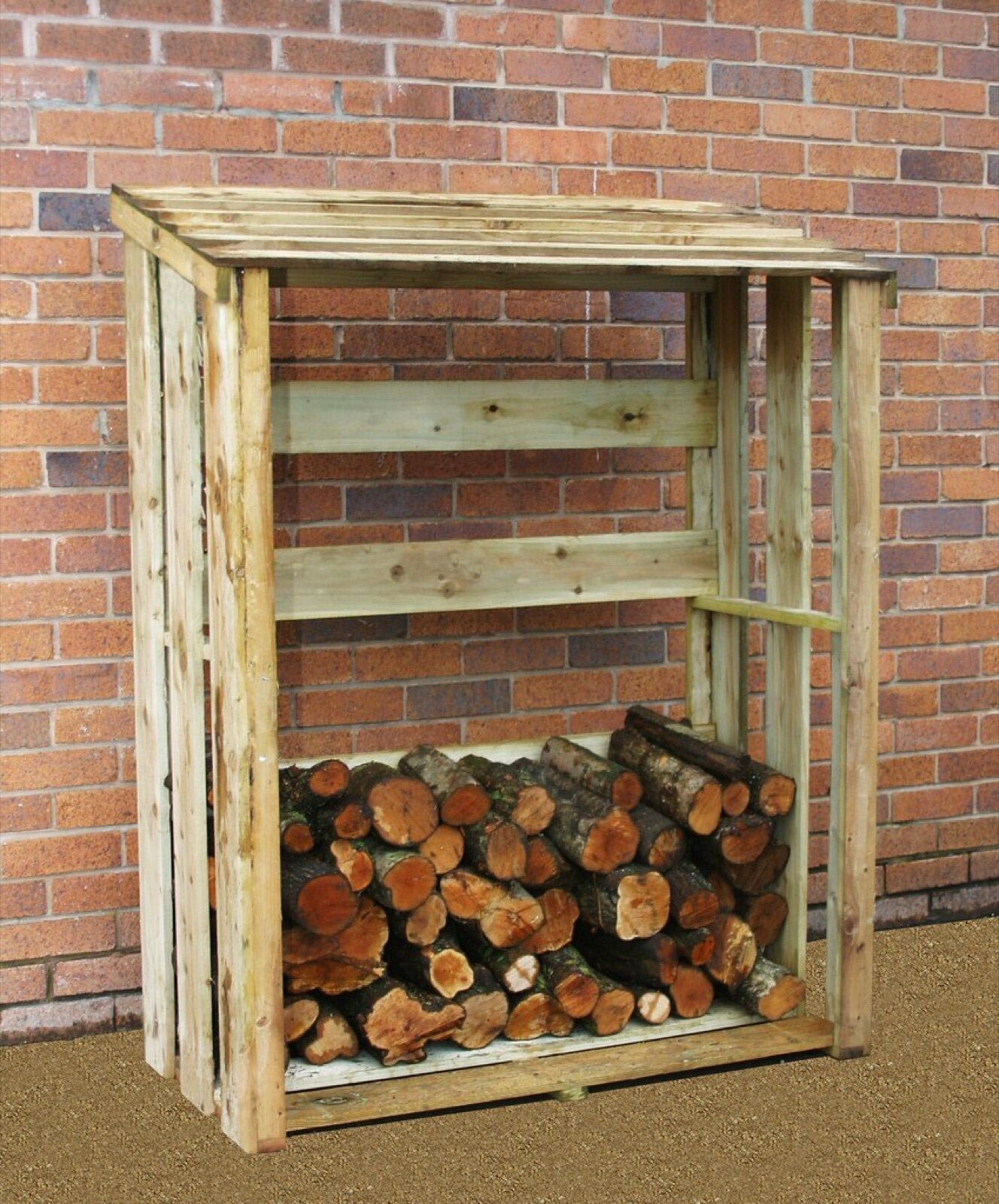 Pressure-treated timber log store with a sloping slatted roof, open front and raised floor, part-filled with split logs