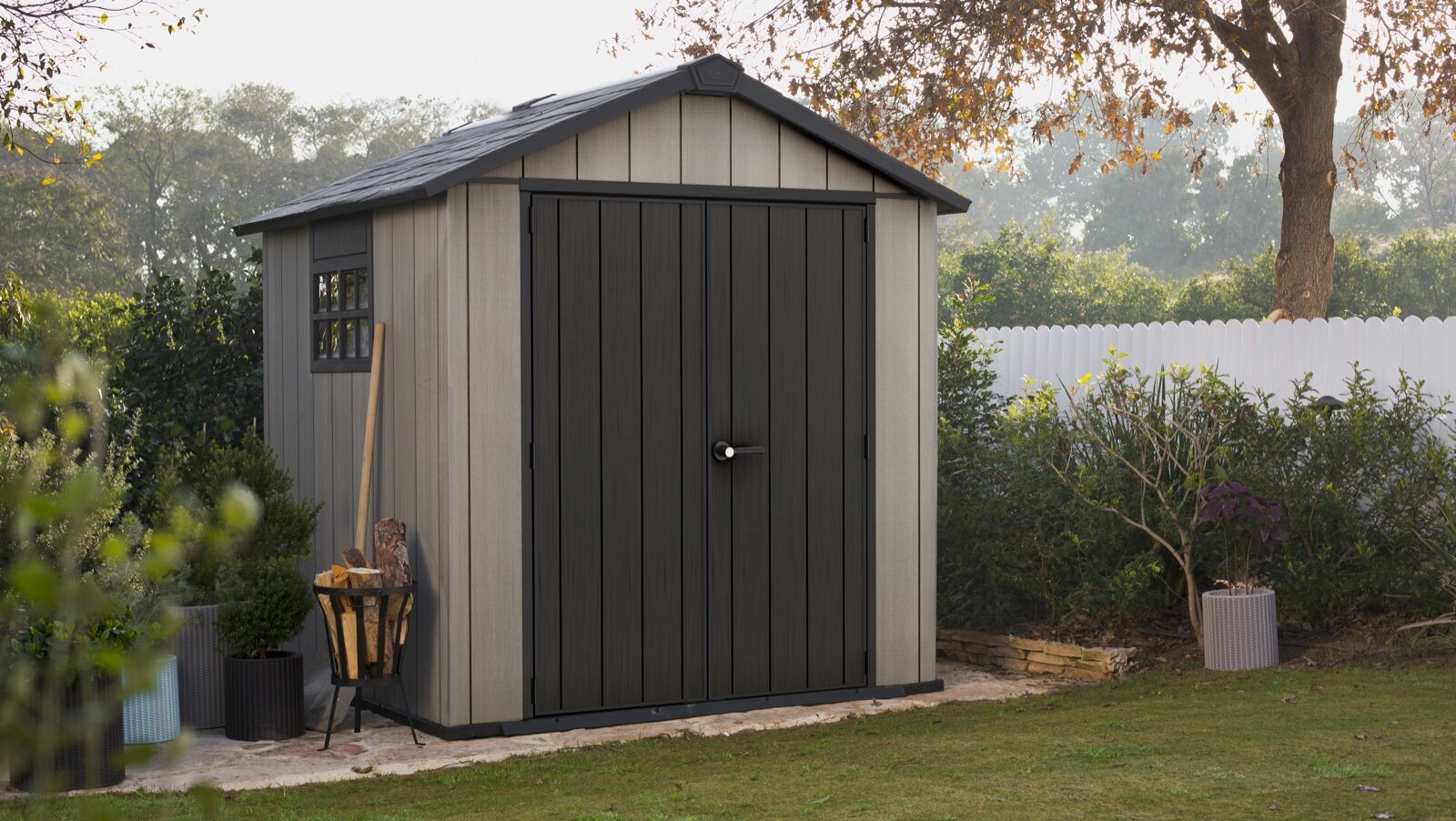 Grey resin apex garden shed with double doors on a patio